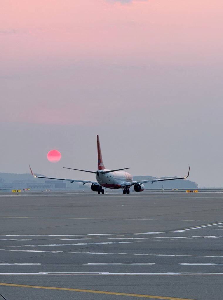 Airplane on a South Korean airport runway at sunset for Europe to Korea flight planning