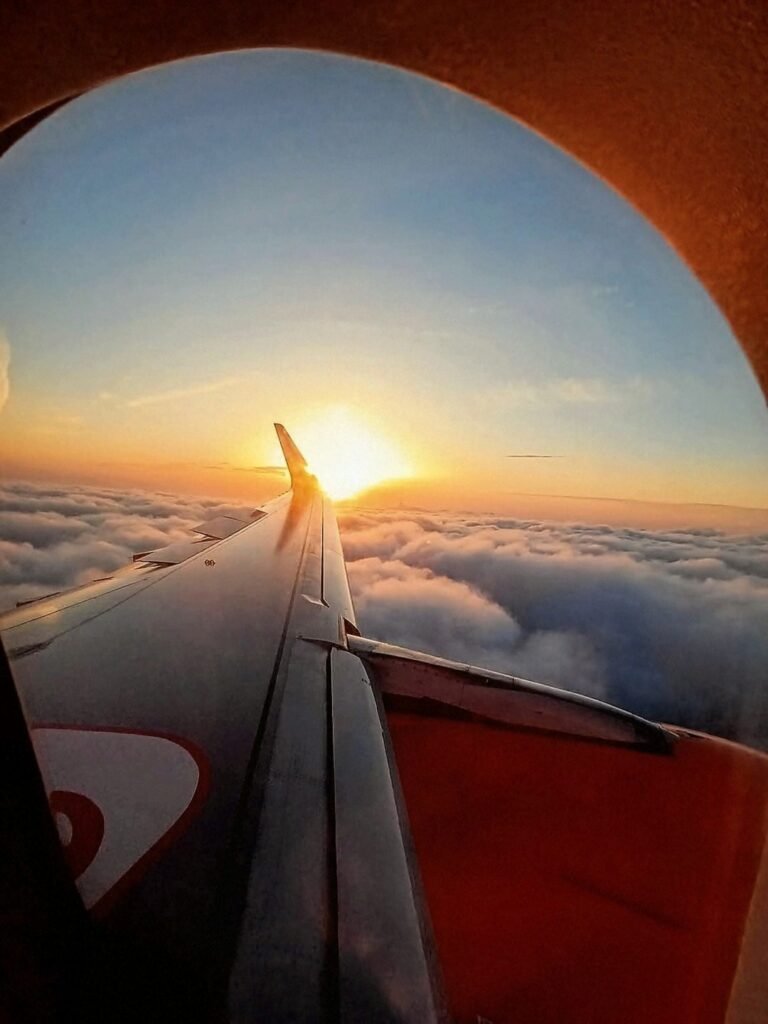 Sunset above the clouds viewed from an airplane window