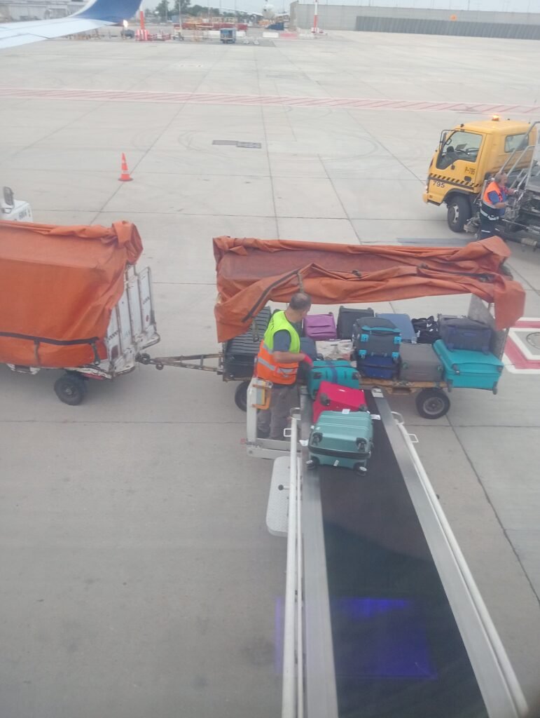 Suitcase being loaded onto an aircraft at an airport