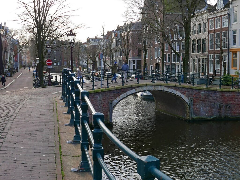 Amsterdam canal and historic brick bridge at Reguliersgracht